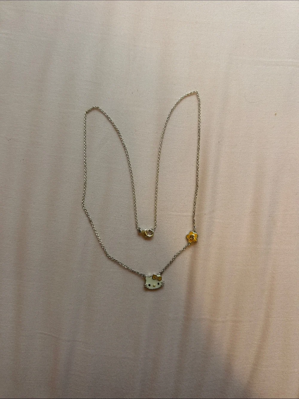 Hello Kitty Silver Necklace with White Enamel Face and Gold Flower Accent